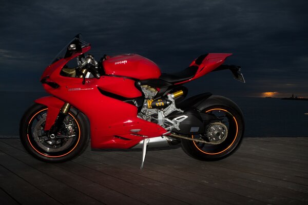 Red Ducati sports bike in the dark of night