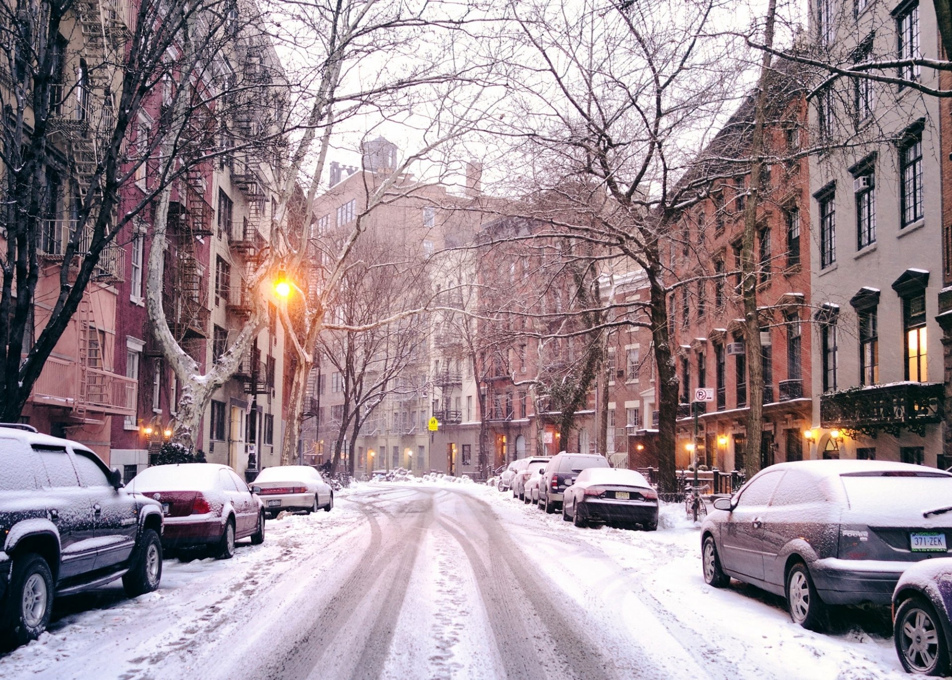 new york usa united states of america city street road snow cars houses buildings trees lanterns light winter