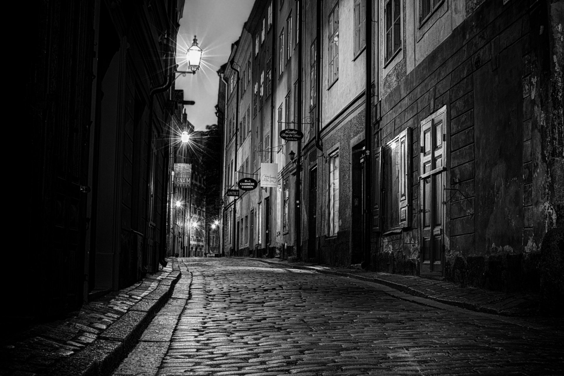 schweden stadt nacht straße pflastersteine straße geschäfte gebäude häuser türen fenster lichter schwarz und weiß