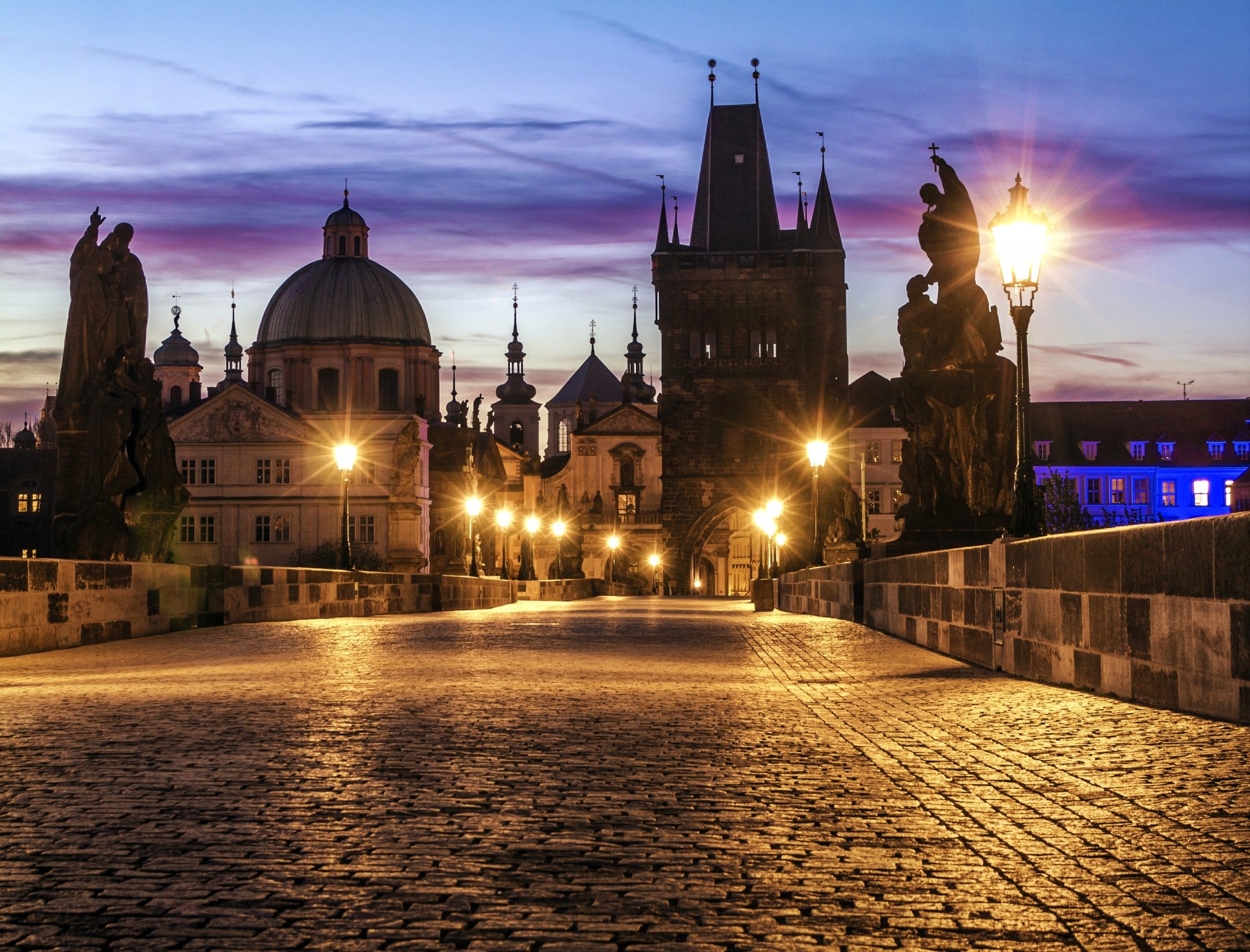 prague czech republic česká republika karlów most charles bridge city architecture buildings sculptures bridge paving stones lights lanterns lighting morning dawn