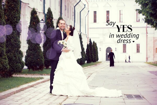 Happy newlyweds on the background of the church