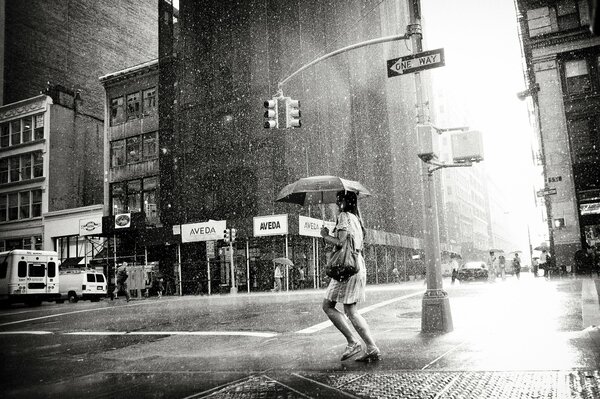 Black and white photo of a girl in the rain