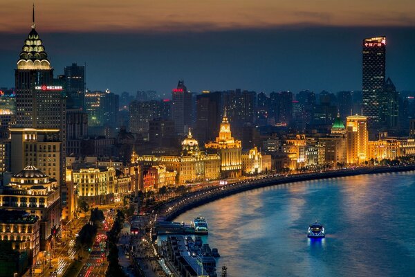 A city lit by lights at night by the river