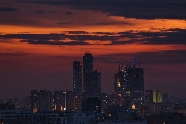 Urban landscape with high-rise buildings under the night sky