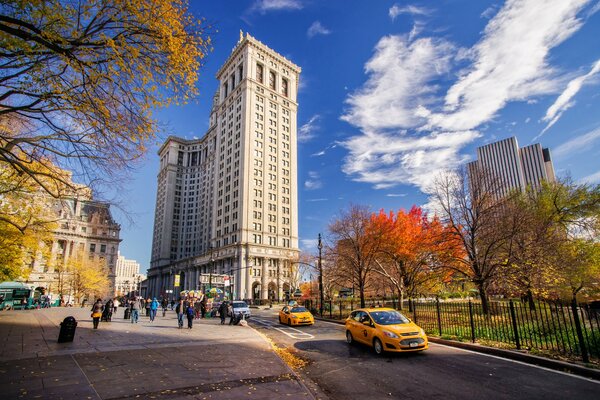 People walk through an autumn Manhattan park