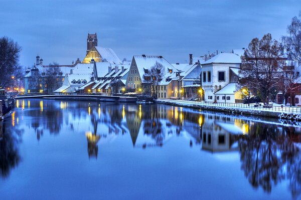 Das Winterdorf spiegelt sich im Wasser wider