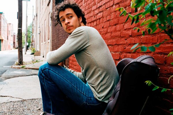 A musician on the street in a chair