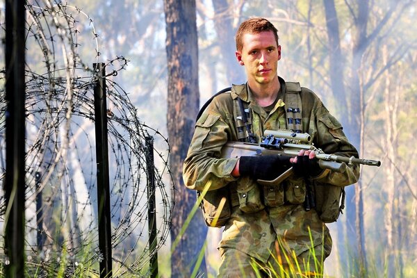 Barbed wire behind the soldier s back