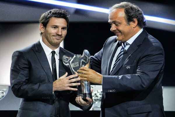 Footballer Lionel Messi receives an award