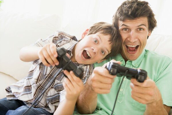 Father and son play a video game console