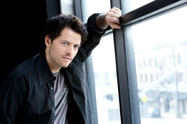 Actor Misha Collins near the window