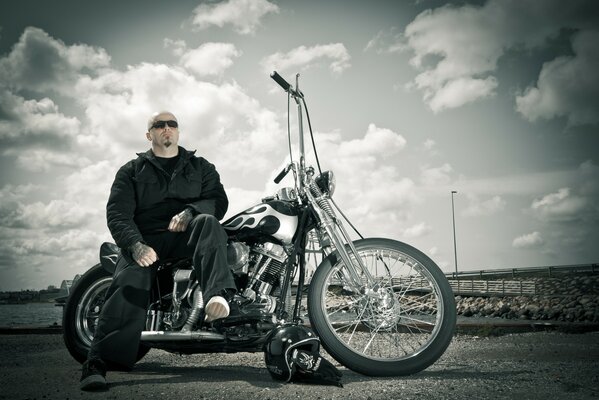 Man with tattoos on harley-davidson biker