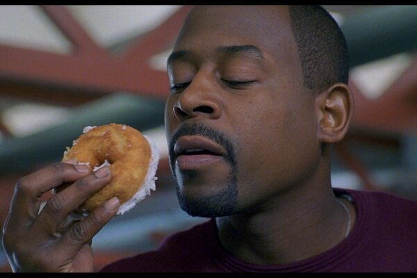 Photo of Martin Lawrence with a donut