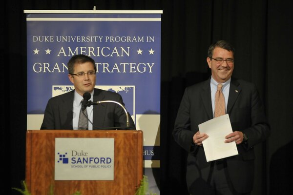 People speaking at the podium of the American University