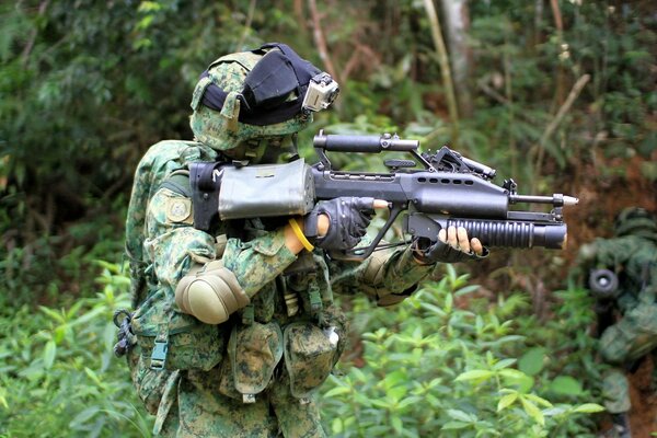 Soldiers with guns are preparing to shoot