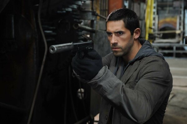 Actor Scott adkins with a gun