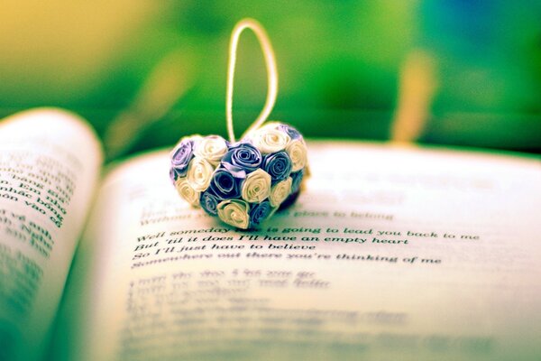 Pendant with colorful roses on the book