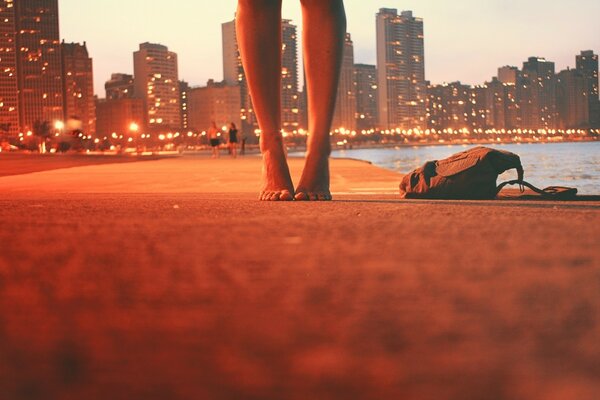 Bare feet on the background of the city