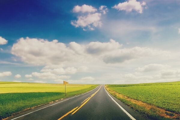 The road to the field. Landscape. Cumulus clouds