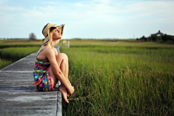 Chica con sombrero en un Prado de verano