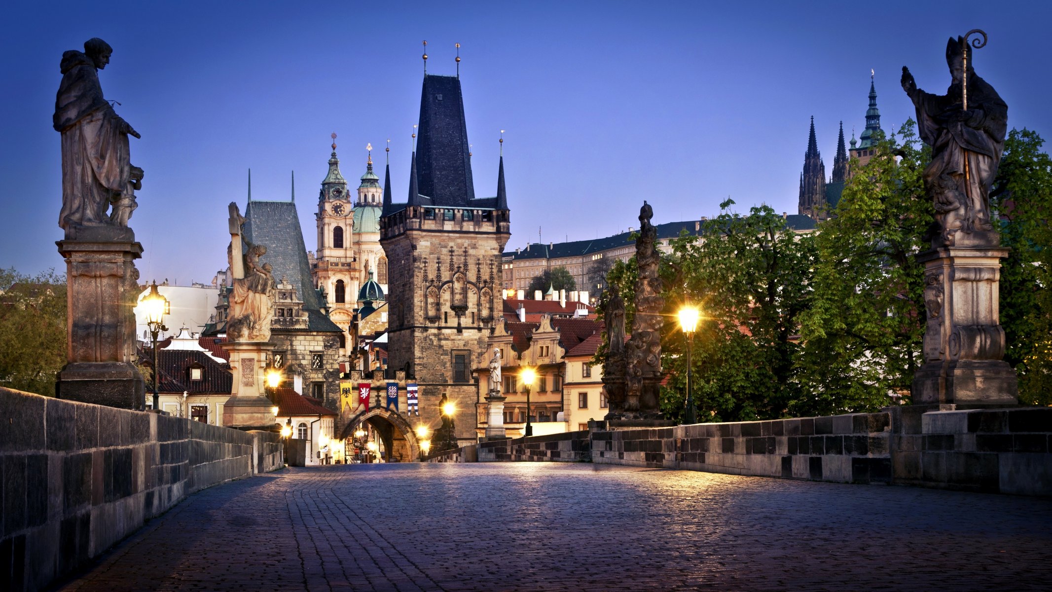 czech republic česká republika prague praha karlův most charles bridge town buildings bridge paving sculpture night lights lamps lighting tree