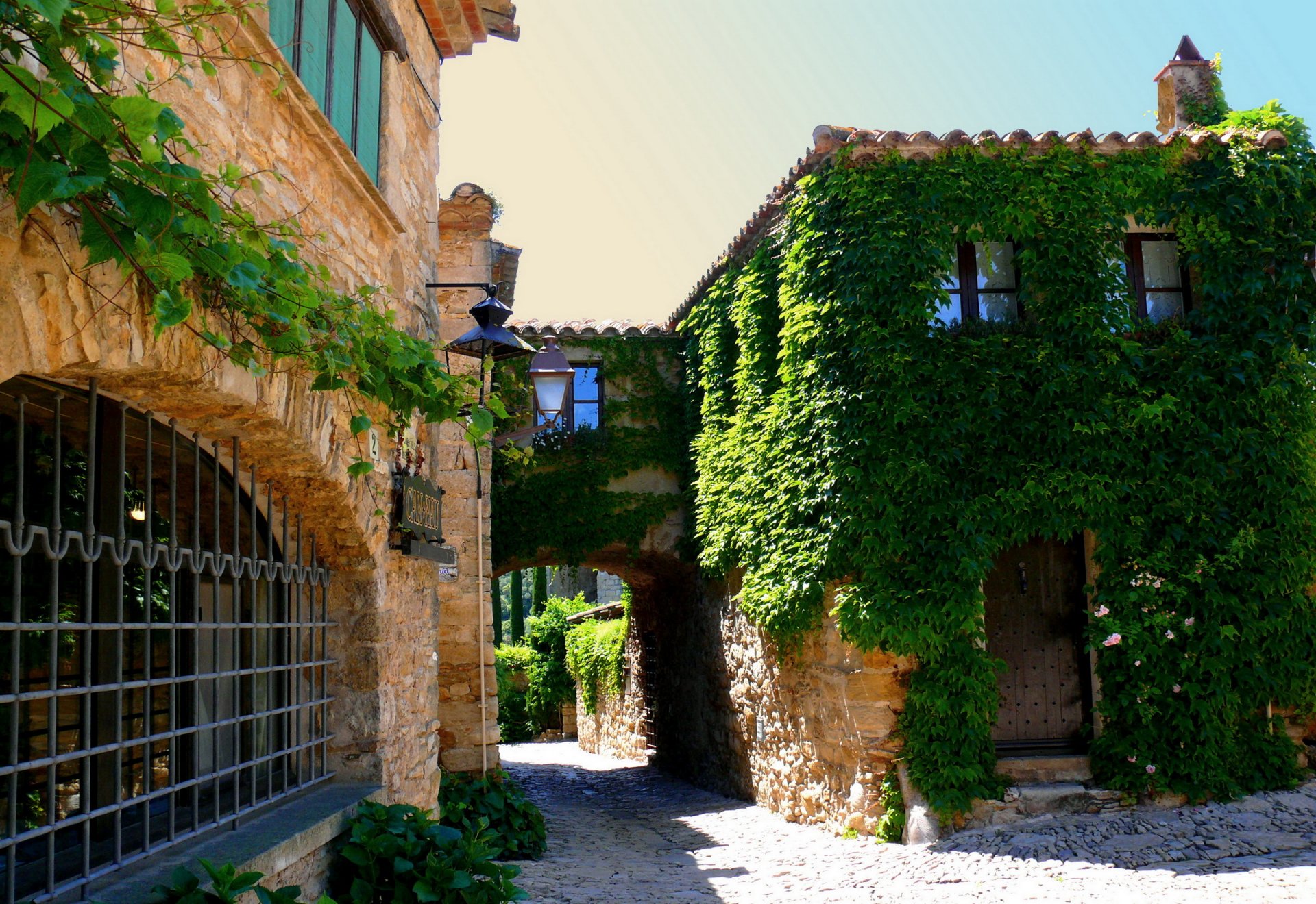 stadt haus spanien katalonien foraljac grün laternen blumen fenster straße schild tür dach steine gitter