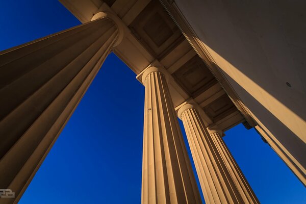 The columns of the city building go up into the sky