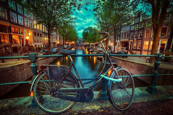 An old bicycle on a bridge in the evening Netherlands