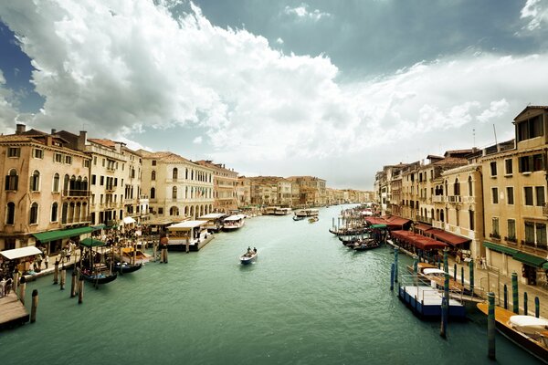 Overcast sky over Venice. Gondolas stand by the water