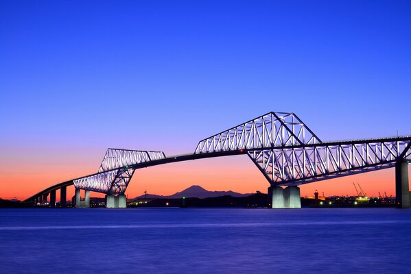 Illuminated bridge with sunset background