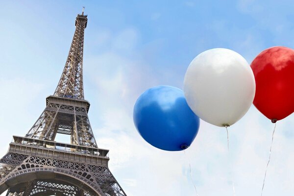 Eiffel Tower on a clear sky background and balloons in the color of the flag