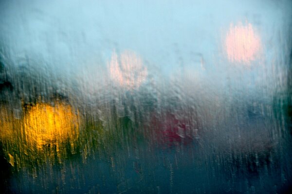 Rain behind the glass and lights in the side