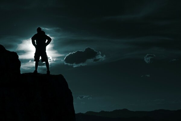 Cielo notturno e uomo sulla sporgenza della montagna