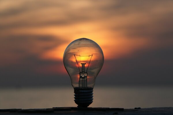 A bright sunset over the sea in a light bulb