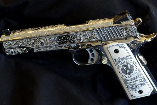 An image of a pistol with an engraving on a black background