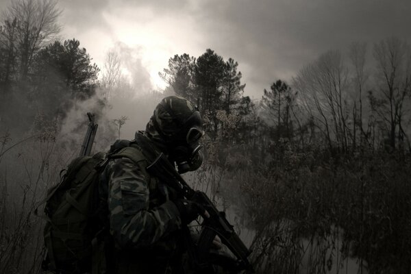 A stalker in a gas mask in the twilight forest