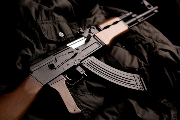 The Kalashnikov assault rifle is lying on the jacket