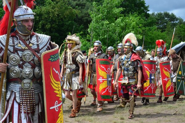 Walking Roman legionaries in armor, helmets and shields