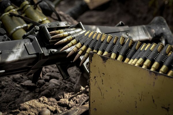 Machine gun and cartridge belt on the ground