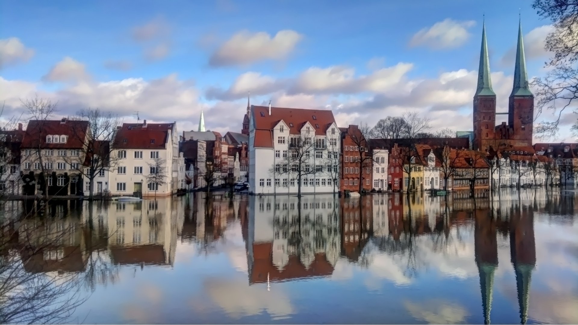 europe town houses buildings tree water reflection sky cloud