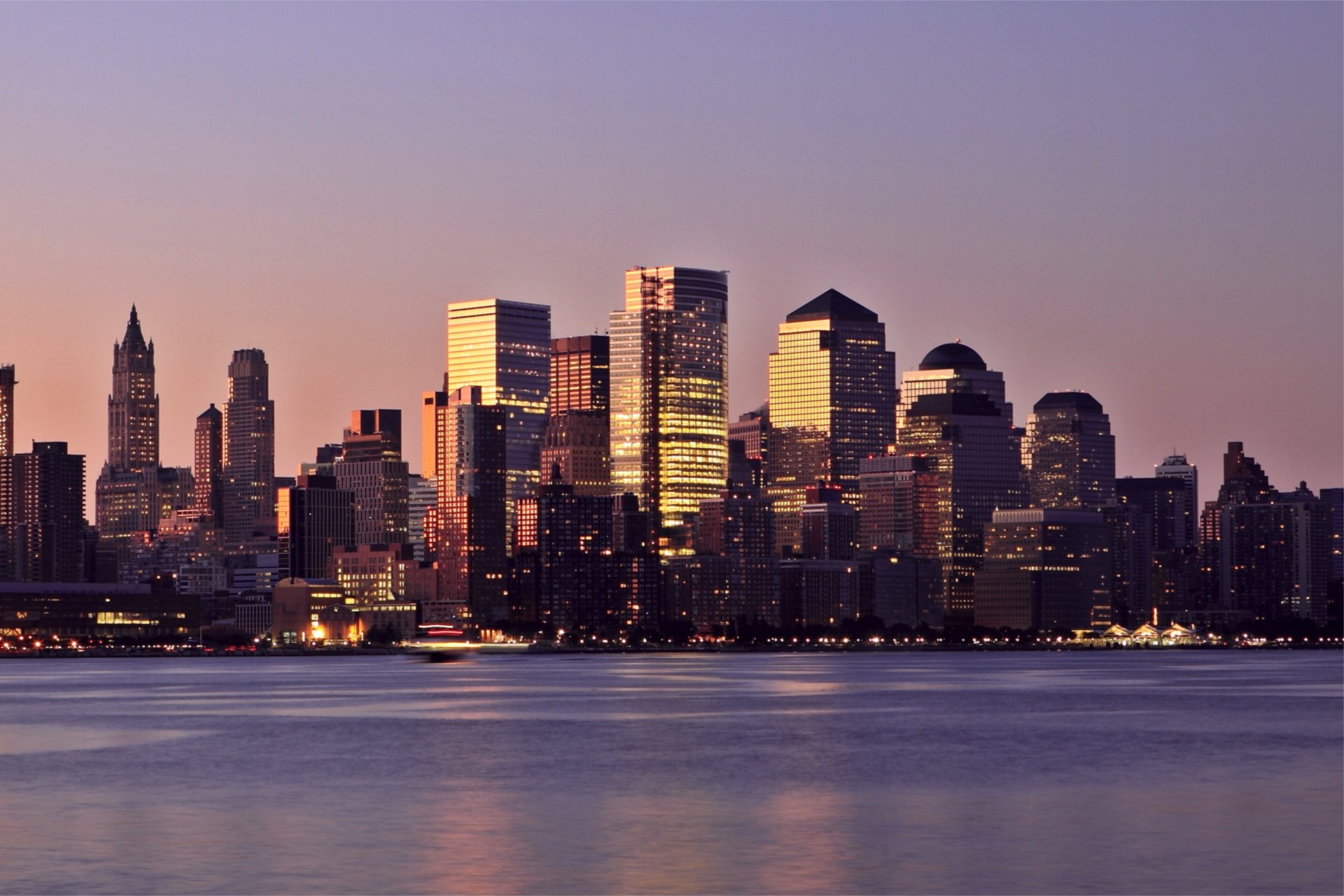 usa new york manhattan district buildings skyscrapers illumination lights river evening sunset