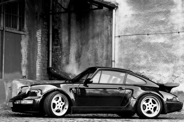 Porsche on the background of concrete walls