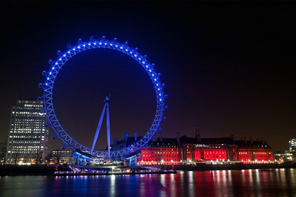 The Ferris wheel stands on the bank of the river