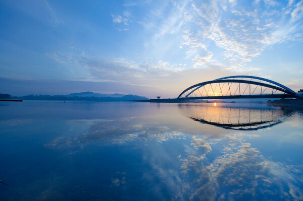 Dawn over the strait with soft morning clouds