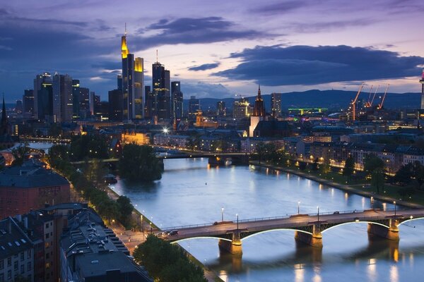 Evening panorama of Frankfurt with the river, bridges. Skyscrapers in the background