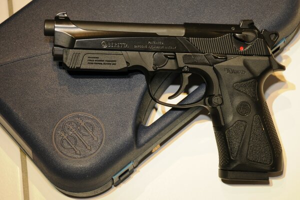 Beretta on the background of a black gun case