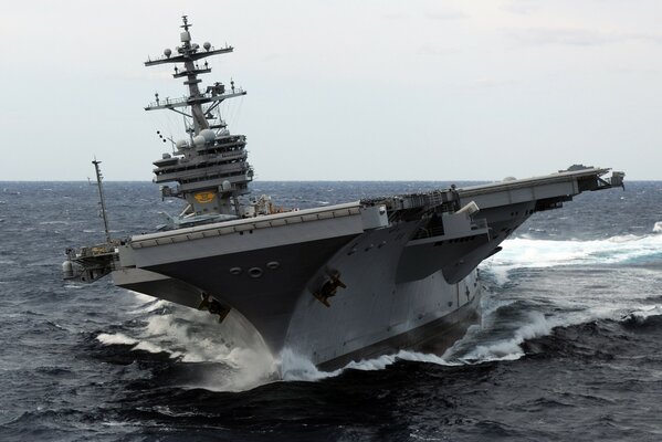 Aircraft carrier in the ocean photo