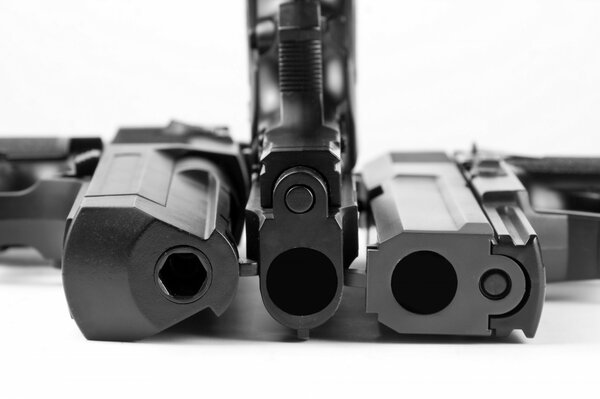 Three gun muzzles on a white background