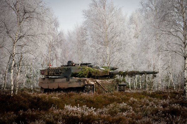 Military tank in the winter forest