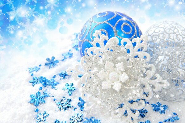 Snowflakes and a blue ball for decorating a Christmas tree